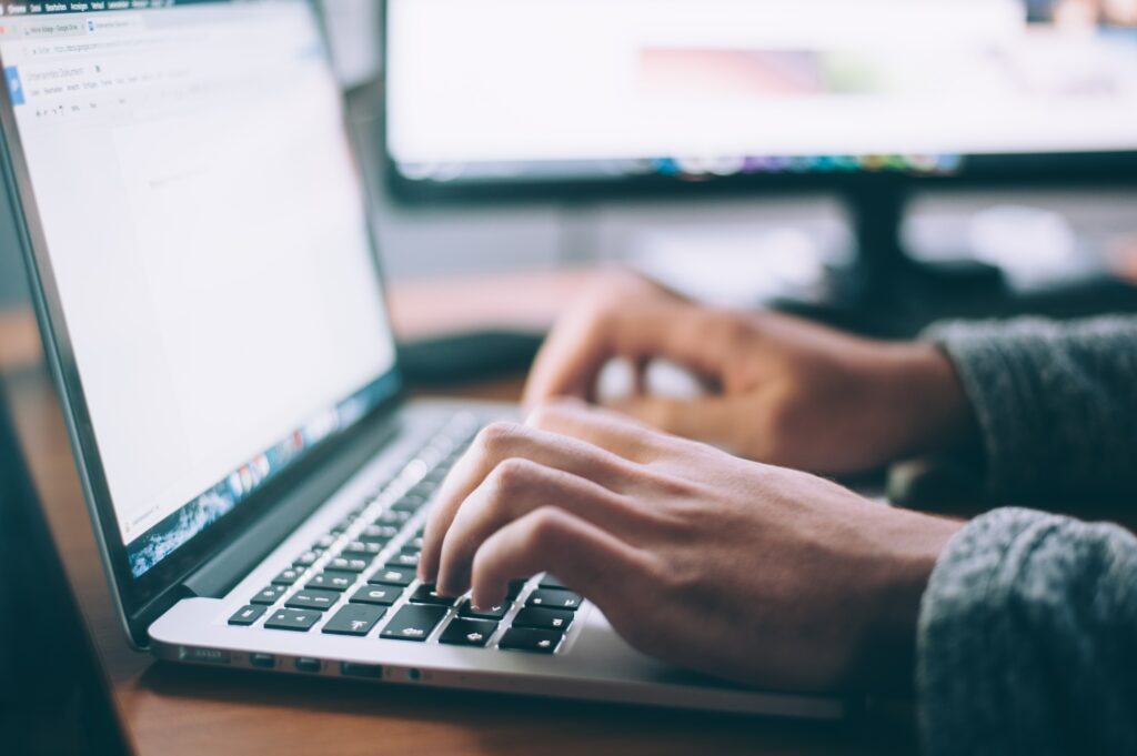 man writing on laptop